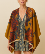 A woman wearing a mustard and red floral shawl draped over her shoulders, styled with a blue patterned dress.
